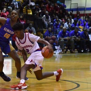 Curie’s Damari Nixon (2) shakes off Simeon’s Frederick Poole (10). Worsom Robinson/For the Sun-Times.