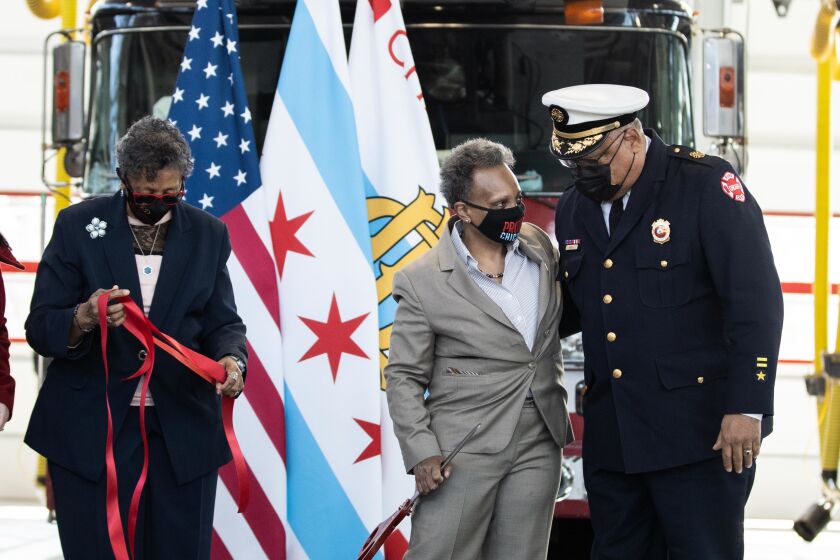 Chicago Mayor Lori Lightfoot speaks to retired Chicago Fire Department Commissioner Richard Ford while Ald. Carrie Austin (34th) holds a ribbon during the opening ceremony of Engine Company 115’s new firehouse at 1024 W. 119th St. in the West Pullman neighborhood, Wednesday morning, March 31, 2021.