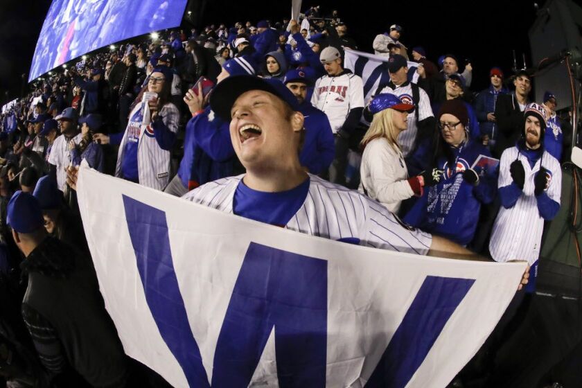Fans cheer after the Cubs’ 3-2 win Sunday in Game 5 sent the World Series back to Cleveland for Game 6. | AP