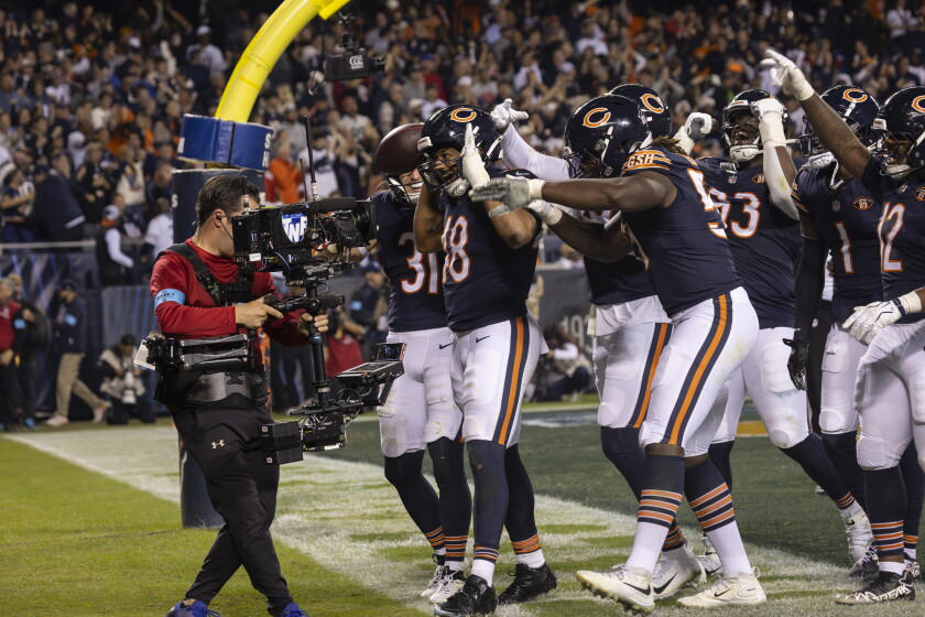 Bears linebacker D’Marco Jackson (48) celebrates with teammates after making an interception during second quarter of the Bears' 30-24 win over the New England Patriots at Soldier Field on Thursday, Oct. 22, 2026.