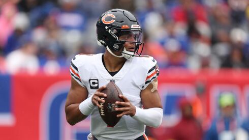 A photo of Bears quarterback Justin Fields throwing against the Giants.
