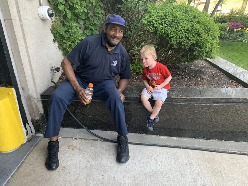 Greg McCarty sitting in his regular spot with the son of a resident who lives at 3900 N. Lake Shore Drive.