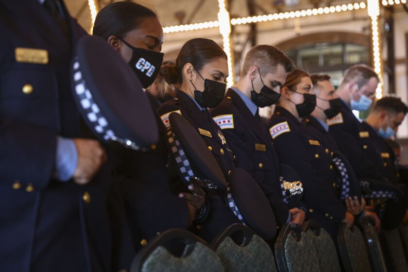 Newly graduated class of police officers bow their heads during a graduation ceremony, Wednesday, Oct. 20, 2021 at Navy Pier. | Anthony Vazquez/Sun-Times