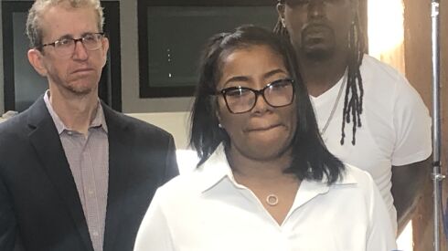 Clarissa Glenn stands beside her attorney, Jon Loevy.