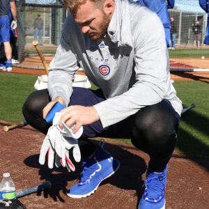 Ian Happ takes off his batting gloves after finishing batting practice on Field 1 at Riverview park, the Spring Training home of the Chicago Cubs, in Mesa, AZ. | John Antonoff/For the Sun-Times
