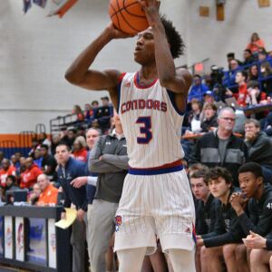 Curie’s DaJuan Gordon (3) puts in a three-pointer against New Trier, Friday 12-28-18. Worsom Robinson/For Sun-Times