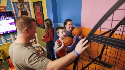 The Proctor family watches as Jack and Kelly Proctor shoot baskets