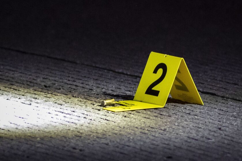 At least one shell casing could be seen as Chicago police investigate in the southbound lanes of Lake Shore Drive near Roosevelt Road, were officials said a 20-year-old man was shot early Sunday.