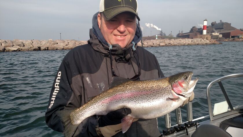 Kyle Danhausen added the beauty of a steelhead against the industrial backdrop of the Indiana shoreline.<br>Credit: Dale Bowman