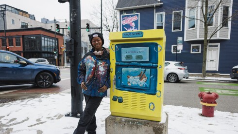 Artist Gabi Bozeman stands next to her work Level Seven: Sunday Self-care at the corner of North Clark Street and West Winnemac Avenue in Andersonville, Wednesday, Dec. 31, 2025.