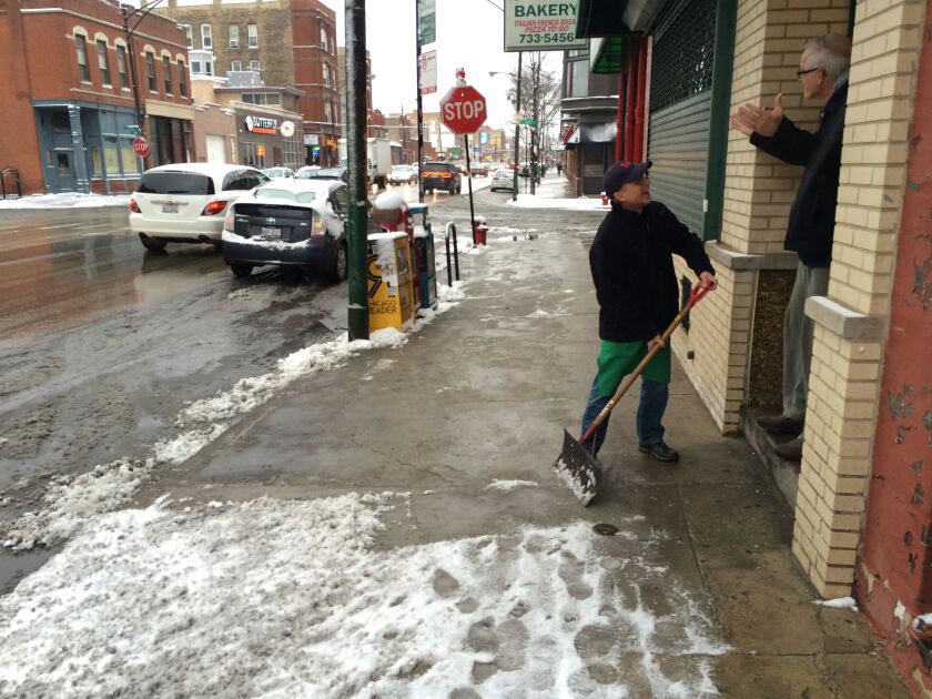 <small><strong>Frank Pedota, 64, owner of Bari Italian Subs, 1120 W. Grand Ave.,<br>stops shoveling for a moment to chat with a neighbor. | Mitch Dudek/Sun-Times</strong></small>