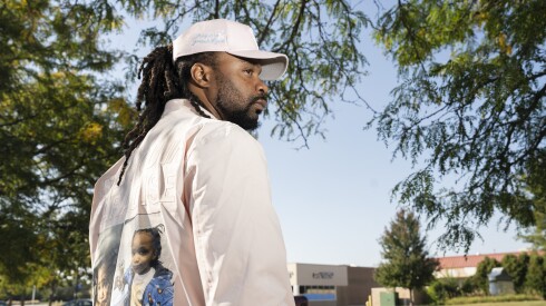 Brandon Washington wears a jacket with pictures of his children Jream Washington and Wyatt Patton, who died in September, outside Steak ’n Shake in Tinley Park, Thursday, Sept. 18, 2025. Washington and Wyatt Patton were pulled from Lake Michigan with their mother Drake Patton.