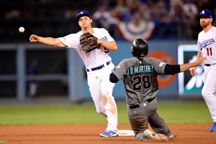 <em>Corey Seager of the Dodgers turns a double play as J.D. Martinez of the Diamondbacks is out at second base in Game 1 of the NLDS at Dodger Stadium on October 6. (Getty Images)</em>