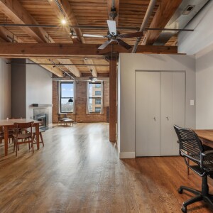 Entryway area with a desk to the right and views of the living room