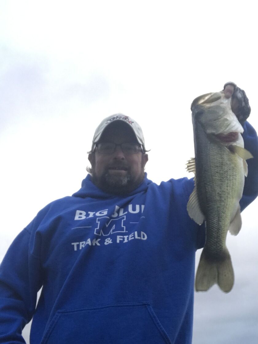 Ken “Husker” O’Malley with a fall largemouth bass from an area lake. Provided photo