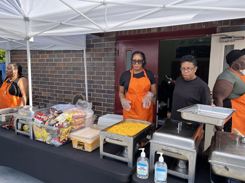 Shameka Barnes (second from right) and other volunteers from Mount Bethlehem Missionary Baptist Church prepare the food they will sell Sunday outside Riot Fest in Douglass Park.