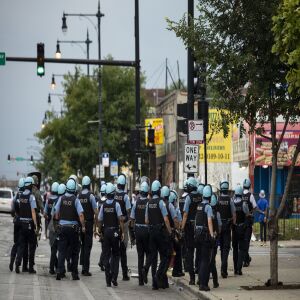 Chicago police officers respond to reports of looting and rioting near West Madison Street and South Keeler Avenue on the West Side, Monday afternoon, Aug. 10, 2020.