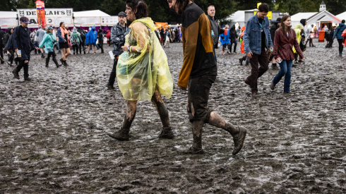 Attendees trek through deep mud as it rains in Douglass Park on Day 3 of Riot Fest, Sunday, Sept. 20, 2026.
