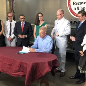 Gov. Bruce Rauner signs the Alternatives to Opioids Act Tuesday at the Chicago Recovery Alliance. | Lisa Mann for Sun-Times