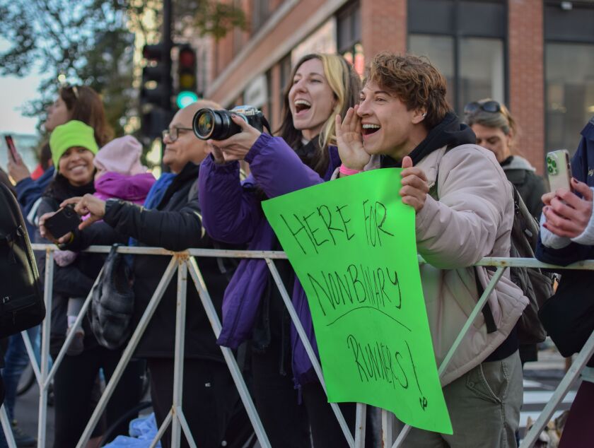 Ariel Robbins and Theo Espy cheer on Cal Calamia near the 17-mile mark during the Bank of America Chicago Marathon on Sunday, Oct. 9, 2022. Calamia was one of 70 runners entered in the event's new non-binary category.