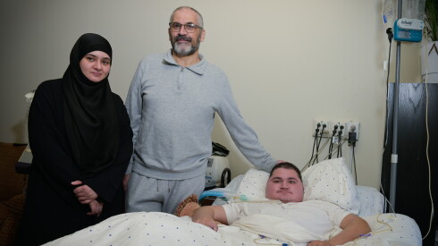 Syrian refugees Asmaa and Mahmoud poses with their disabled son Omar.