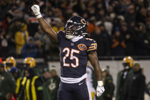 Chicago Bears running back Kyle Monangai celebrates a first down by raising his right arm in the air.