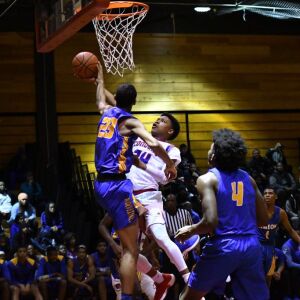 Simeon’s Andre Casey Jr. (23) blocks a shot put up by Curie’s Justin Harmon. Worsom Robinson/For the Sun-Times.