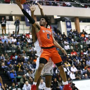 Young’s Tyler Beard (0) floats down the lane for a layup against Morgan Park.