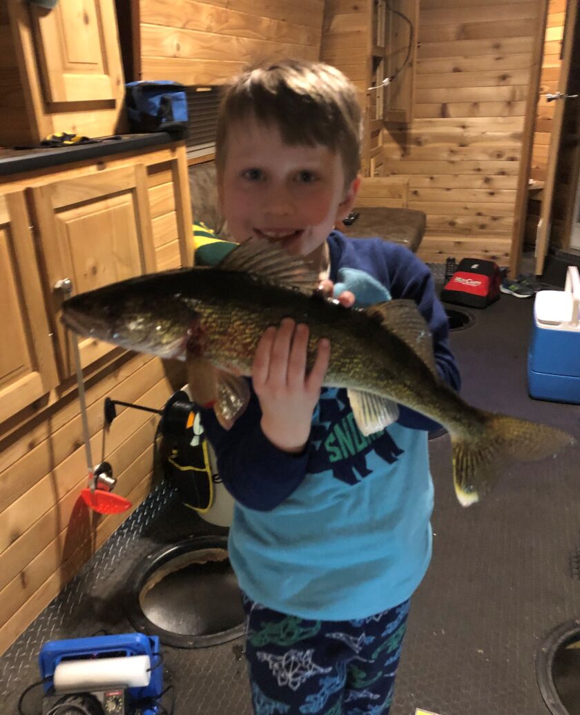 Jace Higgins with a beautiful Lake Mille Lacs walleye. Provided by McQuoids
