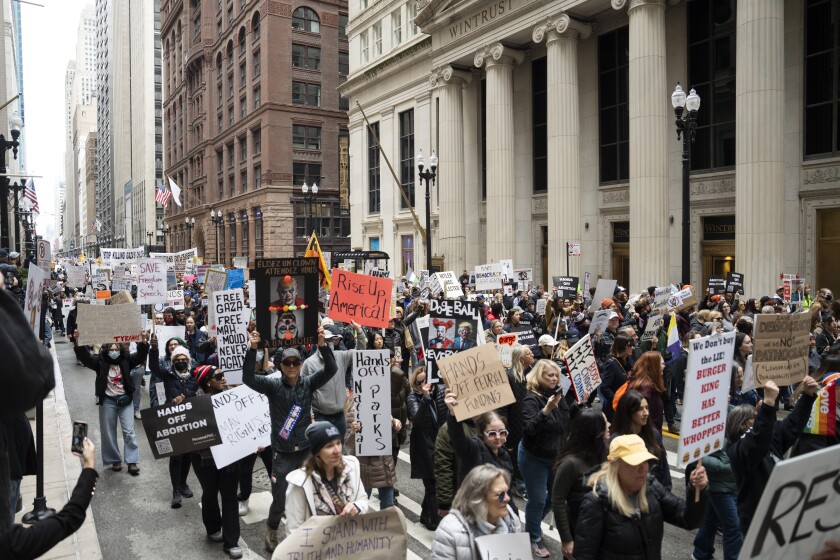 Protesters march down La Salle Drive in the Loop, where thousands opposed President Donald Trump’s policies and Elon Musk’s influence on his administration, Saturday, April 5, 2025. | Pat Nabong/Sun-Times