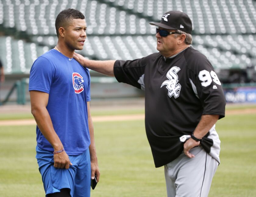 Chicago Cubs pitcher Jose Quintana, left, visits with his former pitching coach Chicago White Sox’s Don Cooper before a baseball game between the two Chicago teams, Monday, July 24, 2017, in Chicago. | Charles Rex Arbogast/Associated Press