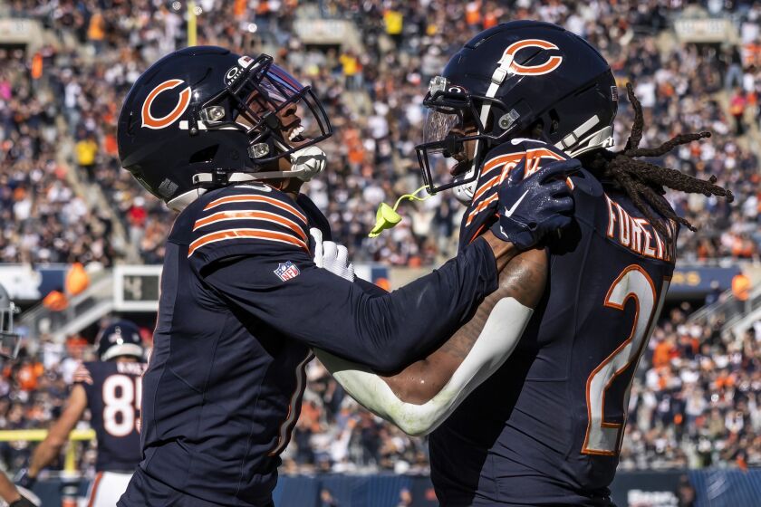 Chicago Bears running back D’Onta Foreman #21 celebrates with wide receiver Darnell Mooney #11 after Foreman scored a touchdown during the third quarter against the Las Vegas Raiders at Soldier Field, Sunday, Oct. 22.