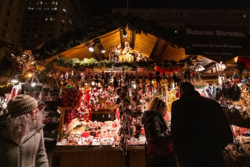 People browse the souvenirs available at the Bavarian Workshop in the Christkindlmarket in Daley Plaza. | Tyler LaRiviere/Sun-Times