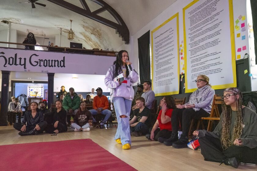 Tanya Lozano leads a few dozen community members in a meditation and breathing exercise during the last Sunday session of the year at Health Hood Chicago.