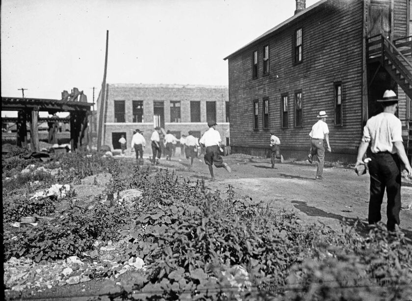 Mob running with bricks during the race riots in Chicago, 1919. | Jun Fujita/Chicago History Museum