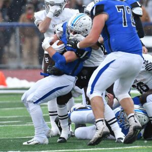 St. Charles North’s Nicholas Demarco (35) gets his helmet twisted. Worsom Robinson/For the Sun-Times.