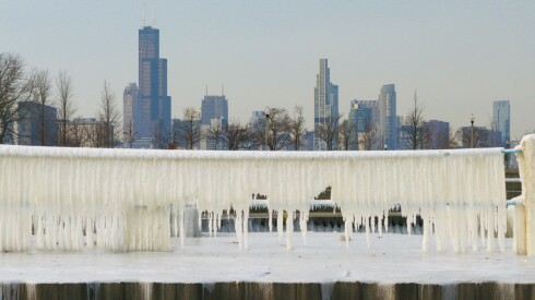The Chicago skyline can be seen past an ice encrusted pier near Oakwood Beach, Monday, Dec. 15, 2025.