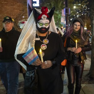 Around 2 dozen people including members of the Sisters of Perpetual Indulgence march along North Halsted Street with electric candles to commemorate Transgender Day of Remembrance, Thursday, Nov. 20, 2025.