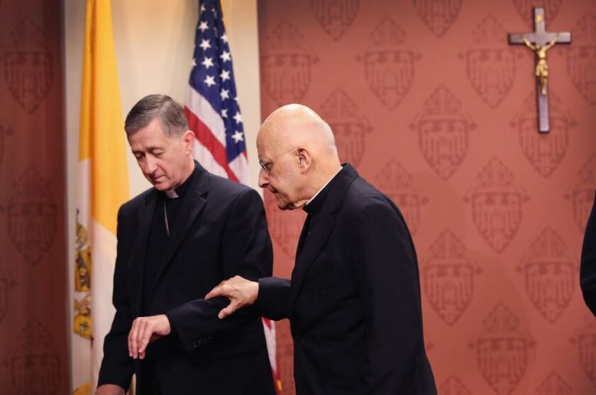 Future Cardinal Blase Cupich (left) helping Cardinal Francis George from the lecturn on Sept. 20, 2014, in Chicago after being named by Pope Francis to succeed George. | Getty Images