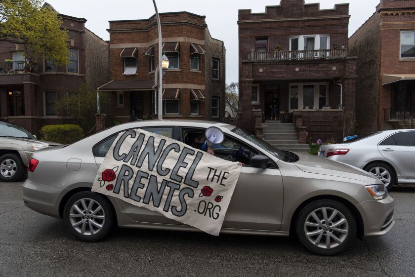 Nick Stender chats for a rent freeze during a vehicle caravan protest Saturday in Albany Park.
