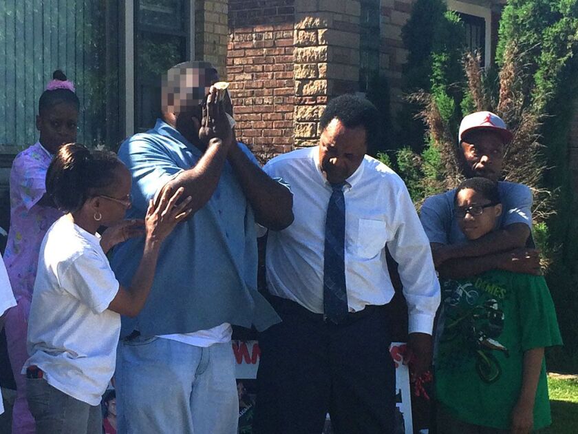 Pamela Johnson’s boyfriend, Eugene Jackson, is comforted Monday by community activist Andrew Holmes. | Frank Main/Sun-Times