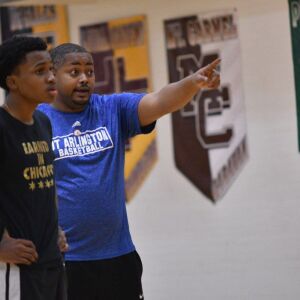Leo assistant coach Walter Fisher talks to Fred Cleveland. Worsom Robinson/For the Sun-Times.