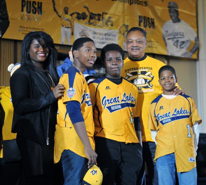 Jesse Jackson honored (l-r) Brandon Green (catcher/pitcher), Joshua Houston (the pitcher for JRW West) and D.J. Butler at a rally at Push. Rainbow Push held the rally for the Jackie Robinson West Little League Team on February 14, 2015. | Al Podgorski / S