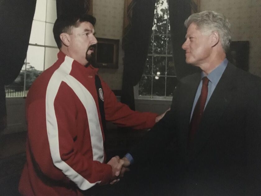 Coach Frank Burns meeting President Bill Clinton.