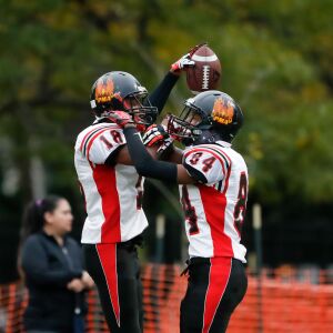 Phoenix’s Lavelle Parker (18) and Dante Chatman (84) celebrate Parker’s touchdown against Marine.