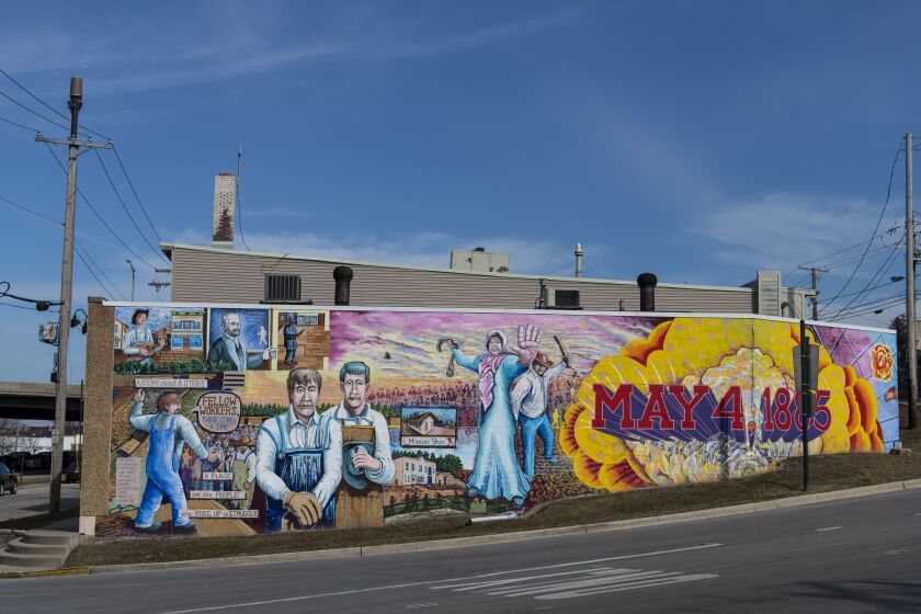 The mural titled “There Comes a Time” in the 100 block of Main Street in Lemont memorializes a deadly clash between quarry workers and militia in 1885.