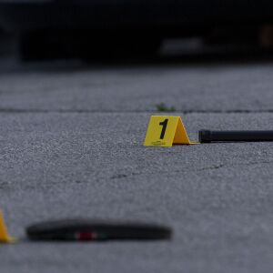 A weapon magazine and a sandal are marked out as evidence at a crime scene where a man was shot in the head and his vehicle stolen in the 6400 block of South Cicero Ave, Monday May 24, 2021.