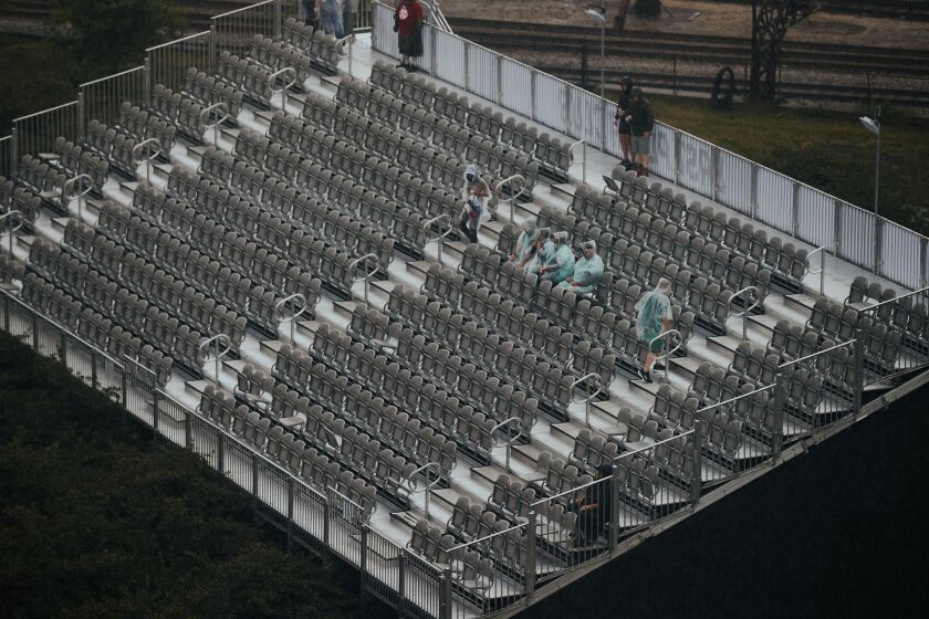Fans wait in the stands on the second day of NASCAR’s first street race in downtown Chicago on Sunday, July 2, 2023. The NASCAR Cup Series’ Inaugural Grant Park 220 race was put on hold due to heavy rain and flooding.