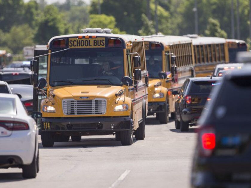 Empty school buses leave after a shooting at Noblesville West Middle School in Noblesville, Ind., on Friday, May 25, 2018. | Robert Scheer/The Indianapolis Star via AP