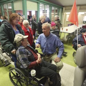 Gov. Bruce Rauner, center, talks with members of the Illinois Veterans Home in January after staying at the home in Quincy, Ill., to better understand the operations there, after it experienced a deadly Legionnaires’ disease outbreak. (Phil Carlson/